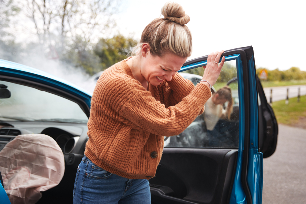 woman with neck injury who is holding neck after being hurt from an Uber accident in Miami in need of an Uber accident attorney