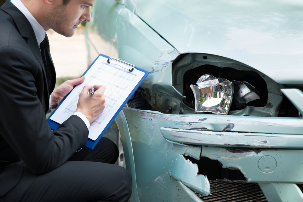Insurance claims adjuster assessing truck accident damage